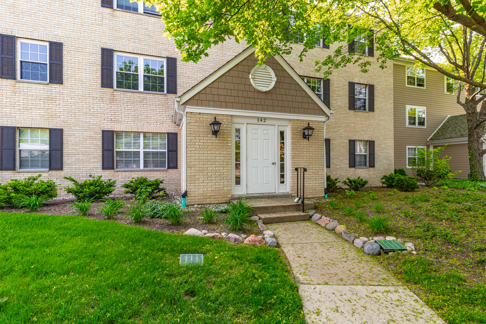 a front view of a house with garden