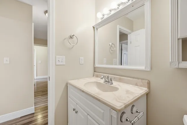 wooden floor fireplace and windows in an empty room