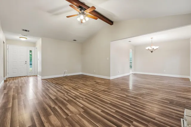 a living room with a fireplace windows and a fireplace