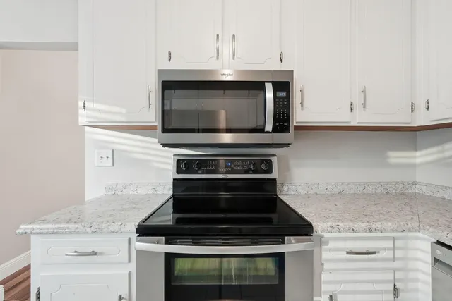 a kitchen with granite countertop cabinets and steel stainless steel appliances
