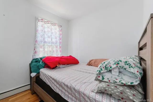 a bedroom with two beds and a window