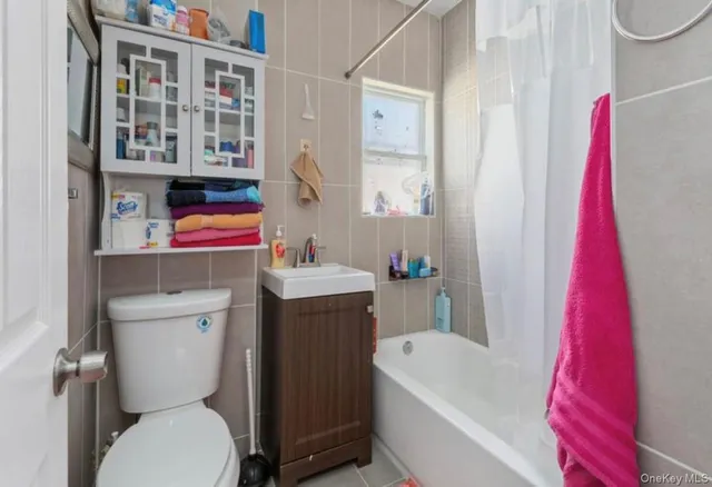 a bathroom with a sink a toilet and a shower