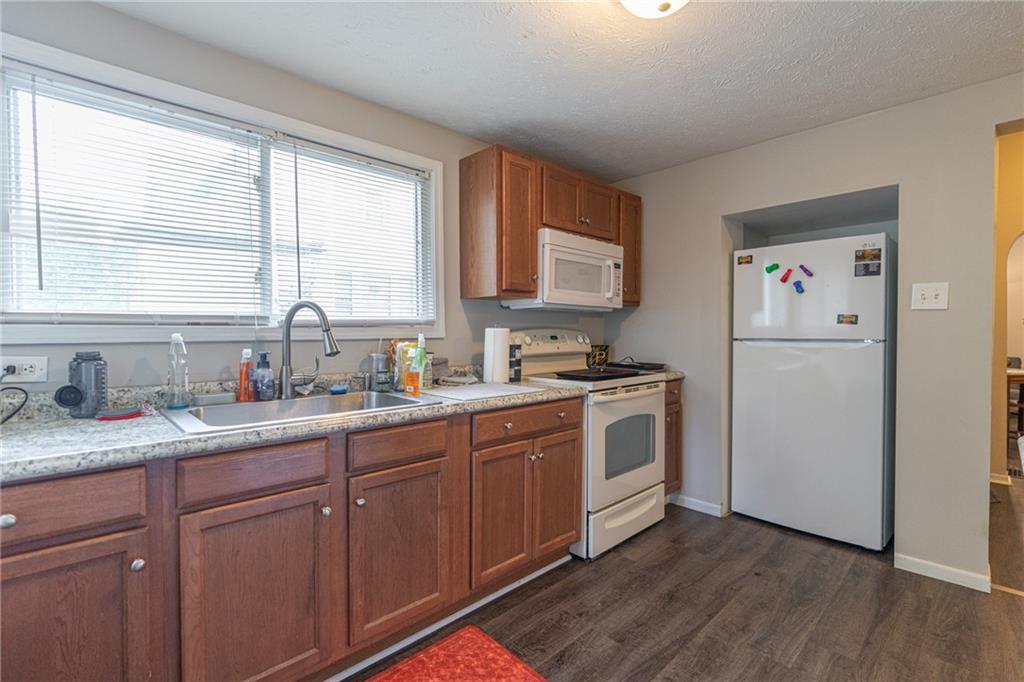 231 Maple Street Slippery Rock, PA 16057 - Photo 6 of 22 a kitchen with a refrigerator stove and sink
