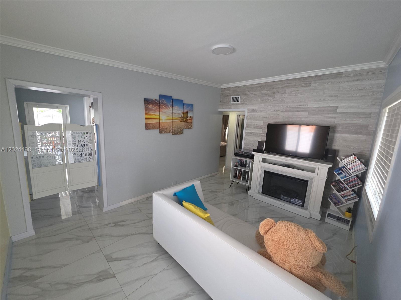 651 East 48th Street Hialeah, FL 33013 - Photo 5 of 52 a living room with furniture and a flat screen tv