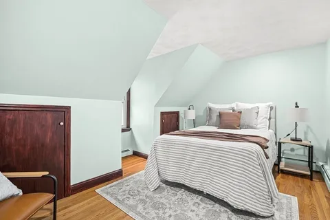 a bedroom with a bed and a dresser
