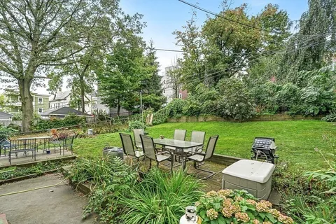 a view of a chair and table on the garden