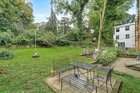 a front view of house with a garden and patio