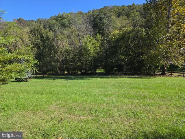 a view of outdoor space with deck and yard