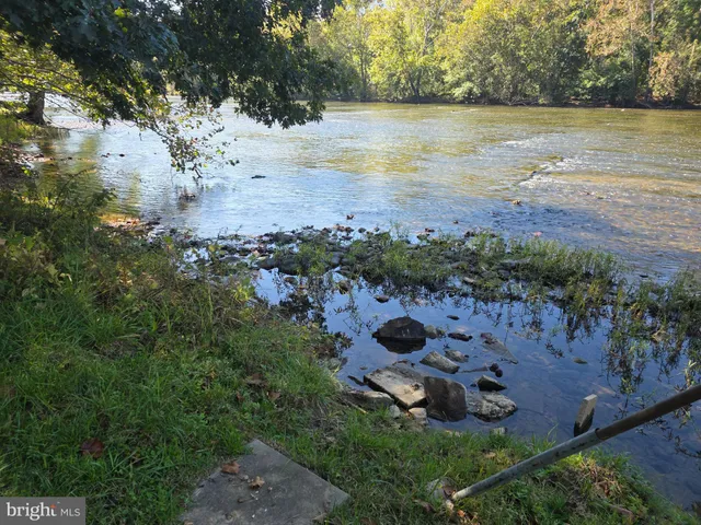 an aerial view of ocean beach and residential house with outdoor space
