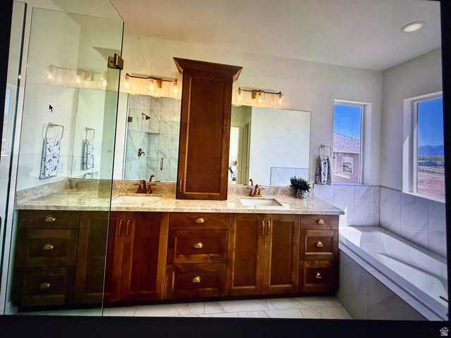 952 East Shilow Road, Unit 131 Erda, UT 84074 - Photo 11 of 12 Spacious bathroom featuring a dual vanity with wood cabinetry, light-toned countertops, and dual mirrors