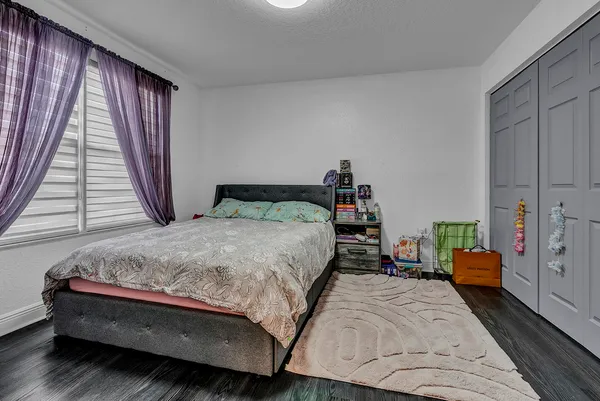 a bed sitting in a bedroom next to a window
