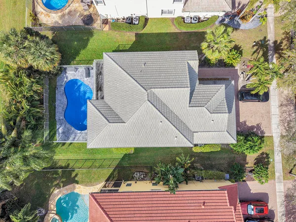a aerial view of a house with a yard and potted plants