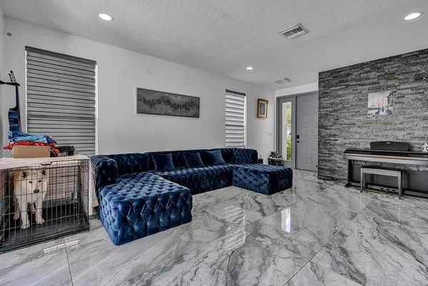 a living room with furniture a fireplace and a flat screen tv