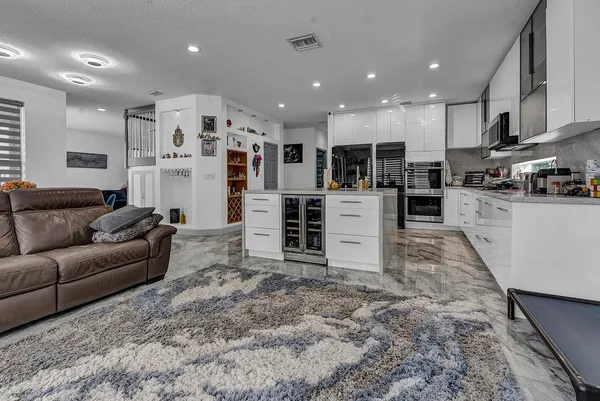 a living room with furniture and kitchen view