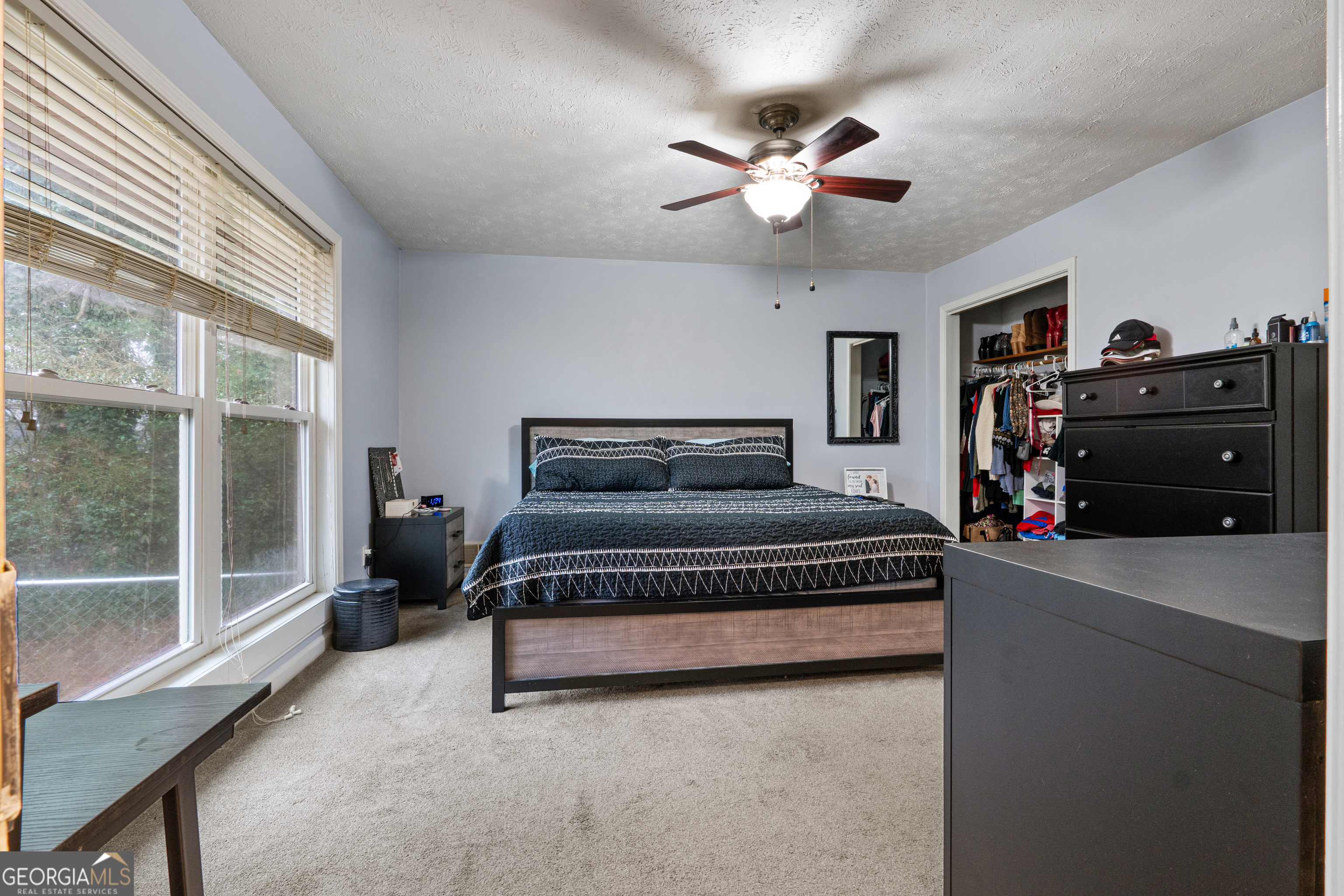 861 Bonner Road Carrollton, GA 30117 - Photo 17 of 38 a bedroom with a large bed and a chandelier