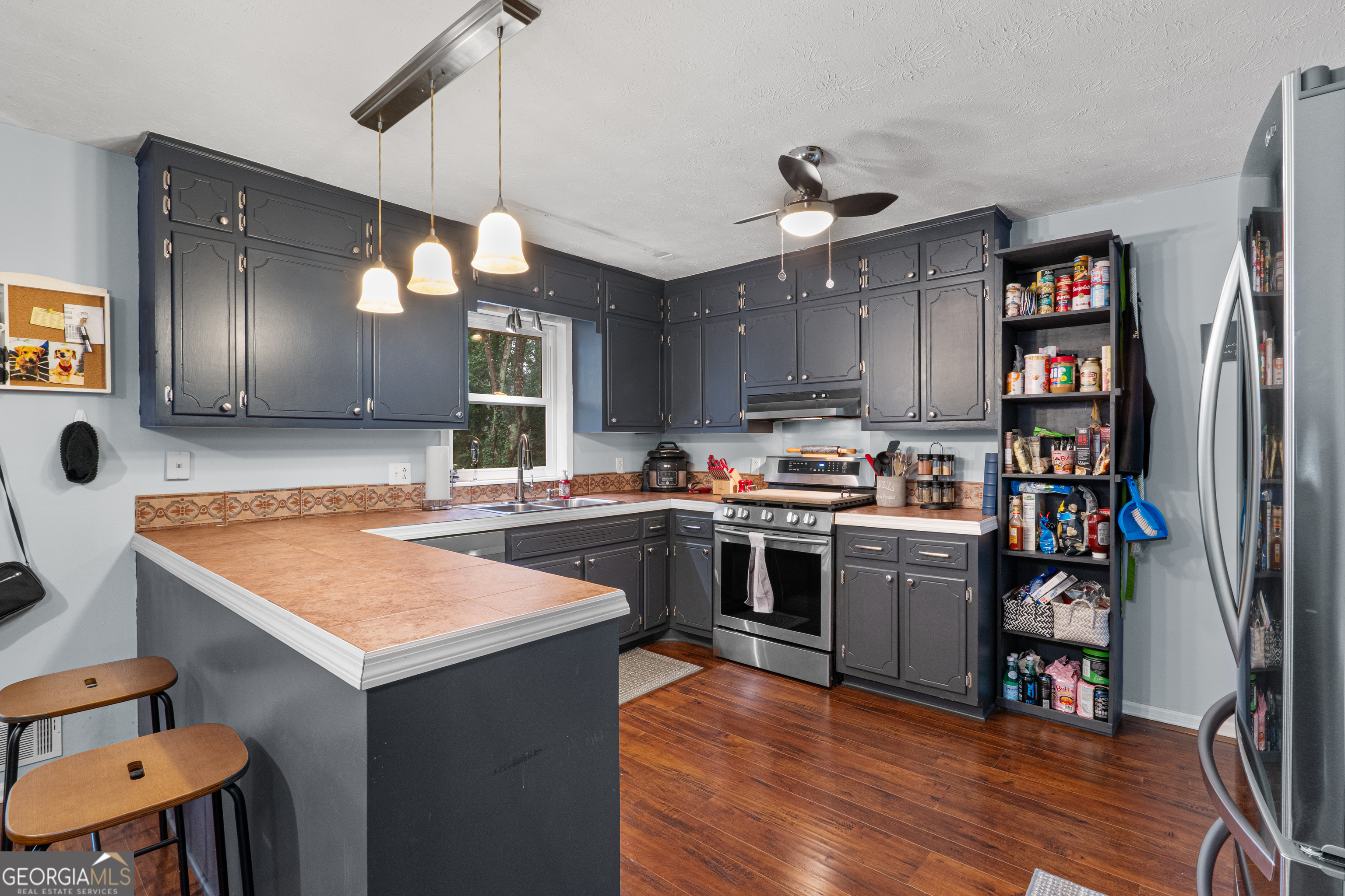 861 Bonner Road Carrollton, GA 30117 - Photo 3 of 38 a kitchen with kitchen island a counter top space a sink stainless steel appliances and cabinets