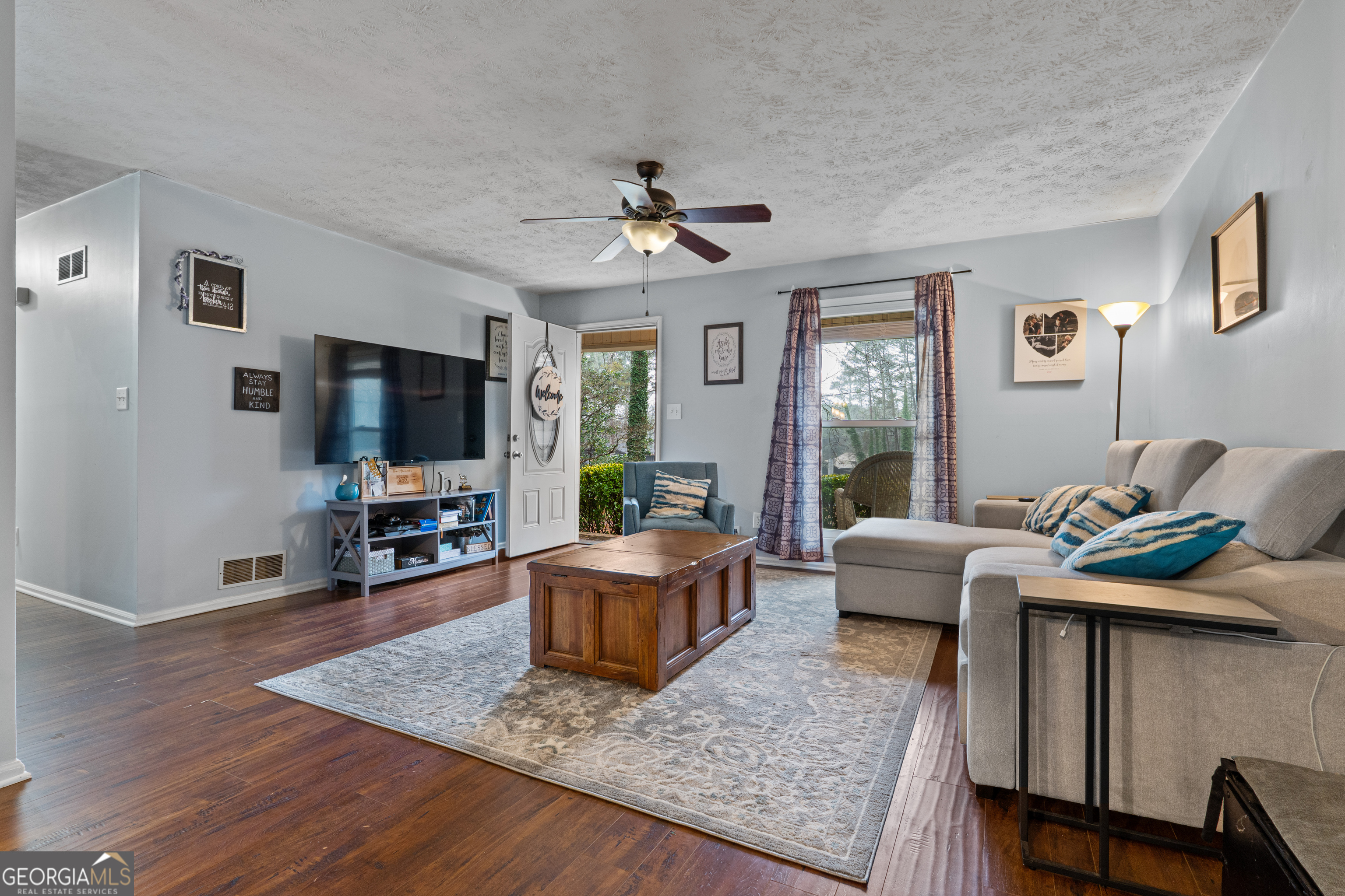 861 Bonner Road Carrollton, GA 30117 - Photo 8 of 38 a living room with furniture and a flat screen tv