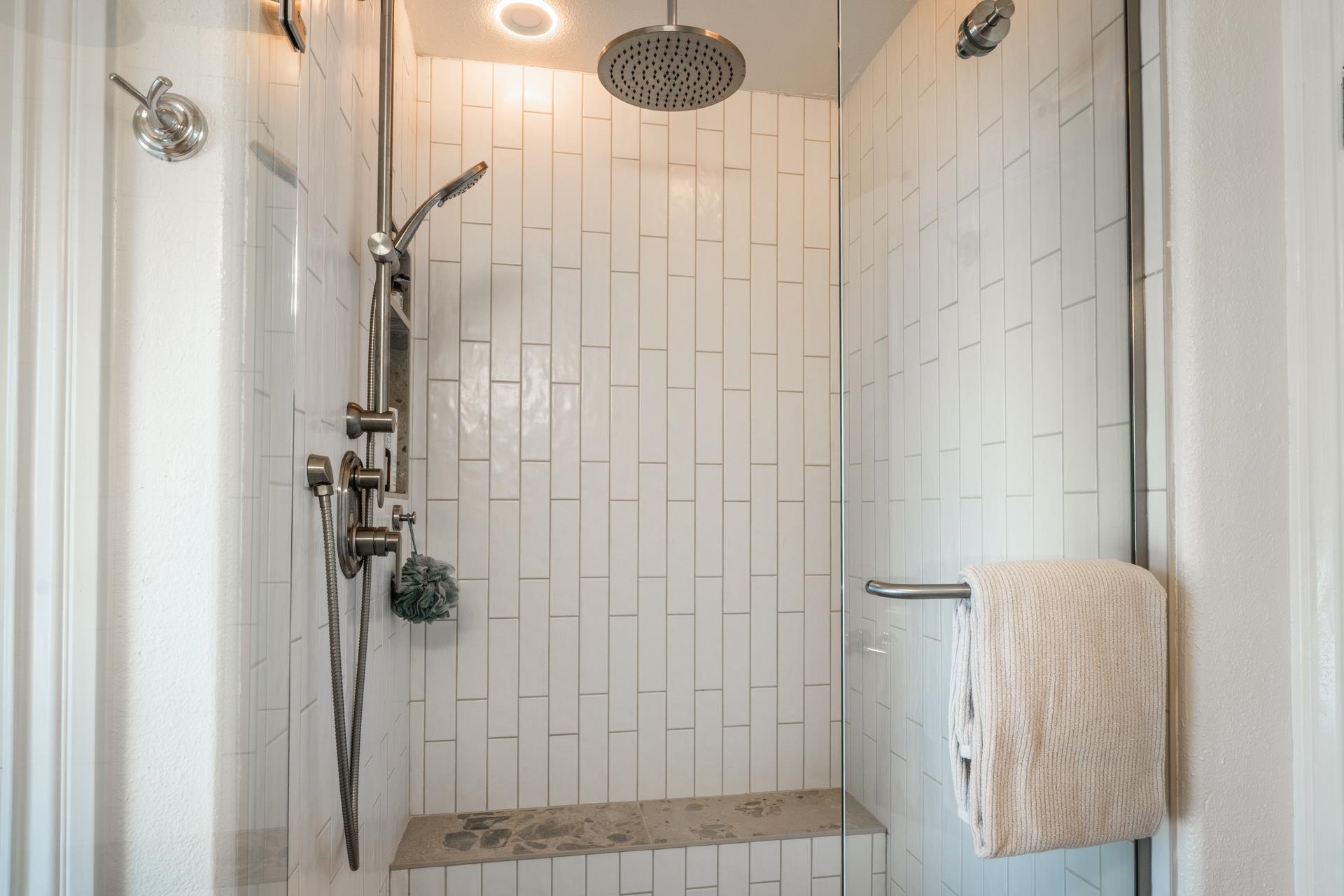 1787 Old Mammoth Road, Unit 2 Mammoth Lakes, CA 93546 - Photo 20 of 29 Shower enclosure featuring vertical subway tile, glass partition, rain shower head, handheld shower