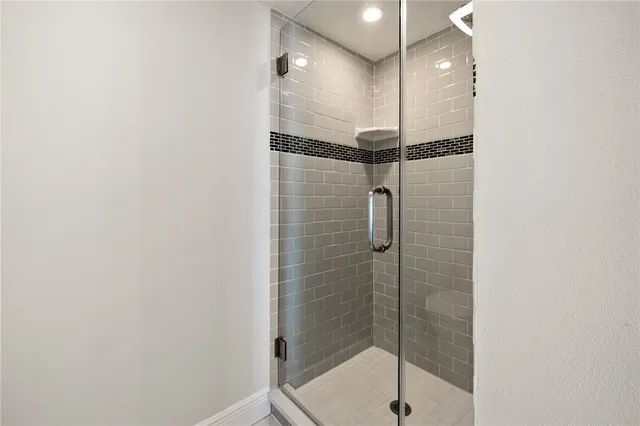 a bathroom with a shower and a sink