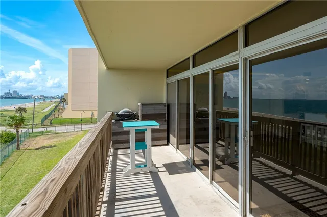 a balcony with view of swimming pool
