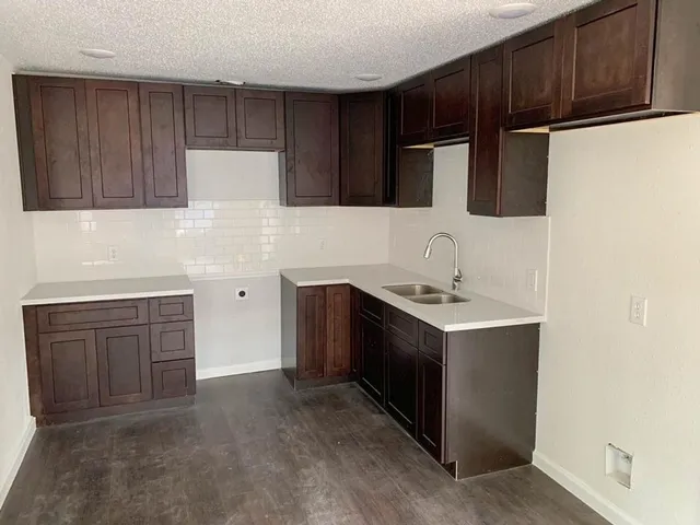 a kitchen with a sink and a refrigerator