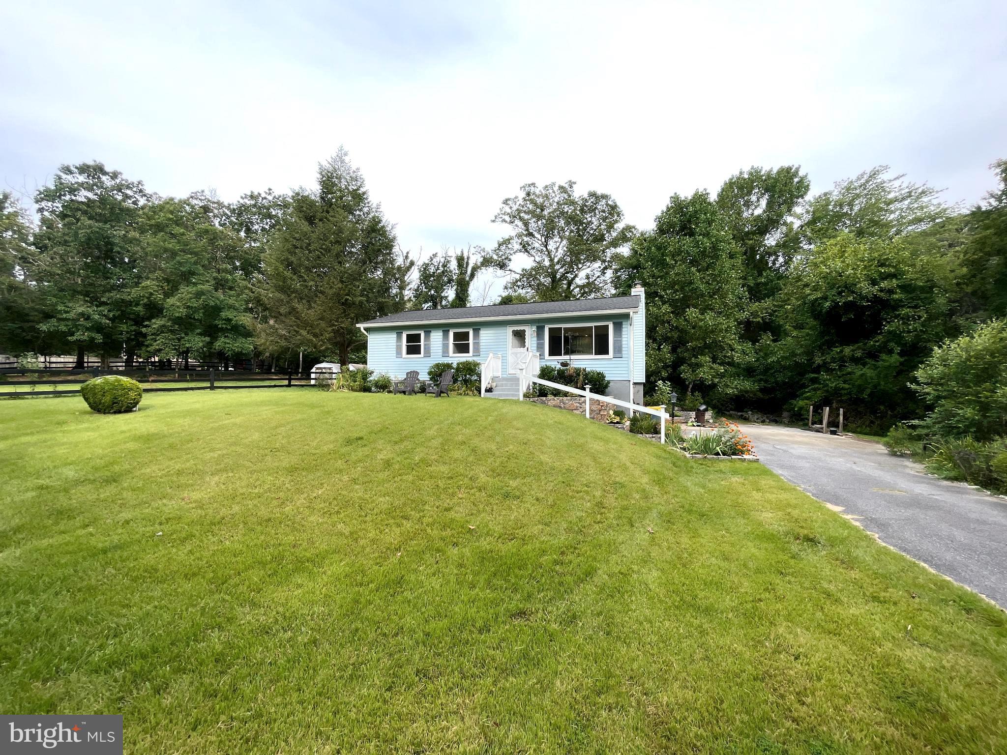 a view of a house with pool and sitting area