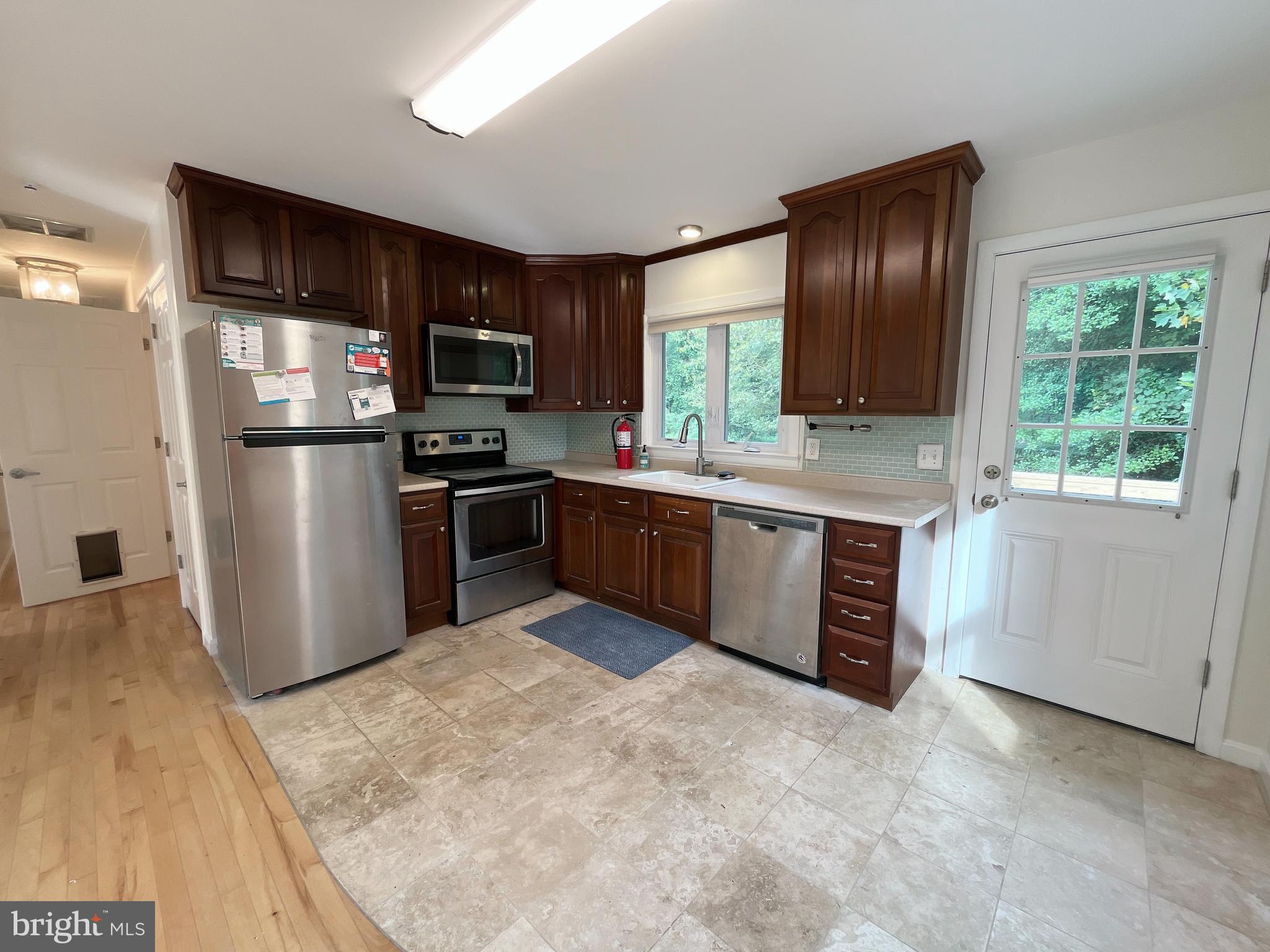 982 Shore Acres Road Arnold, MD 21012 - Photo 11 of 26 a kitchen with stainless steel appliances granite countertop a stove top oven a sink and a refrigerator