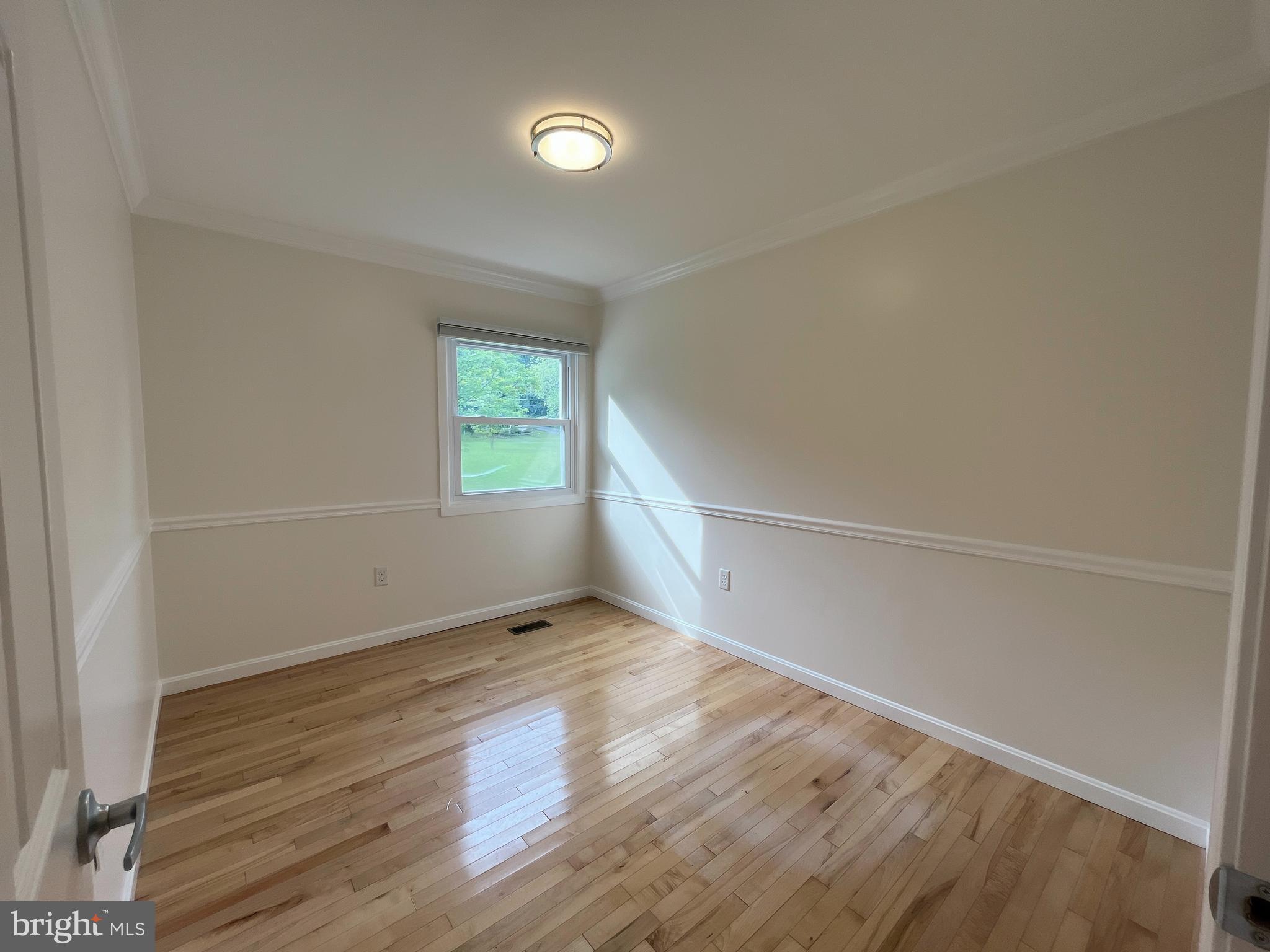 982 Shore Acres Road Arnold, MD 21012 - Photo 14 of 26 a view of empty room with wooden floor and fan