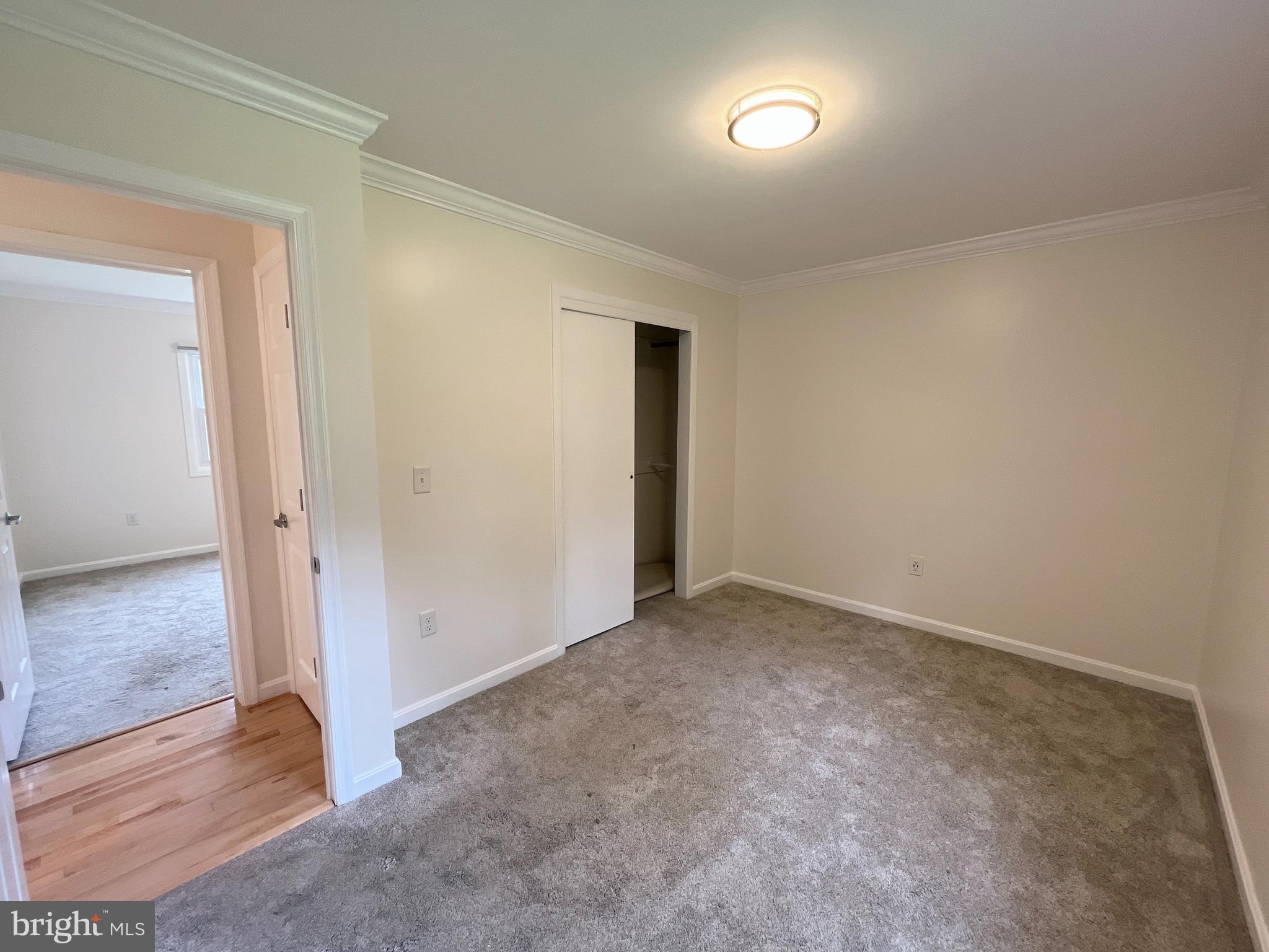 982 Shore Acres Road Arnold, MD 21012 - Photo 16 of 26 an empty room with wooden floor and windows