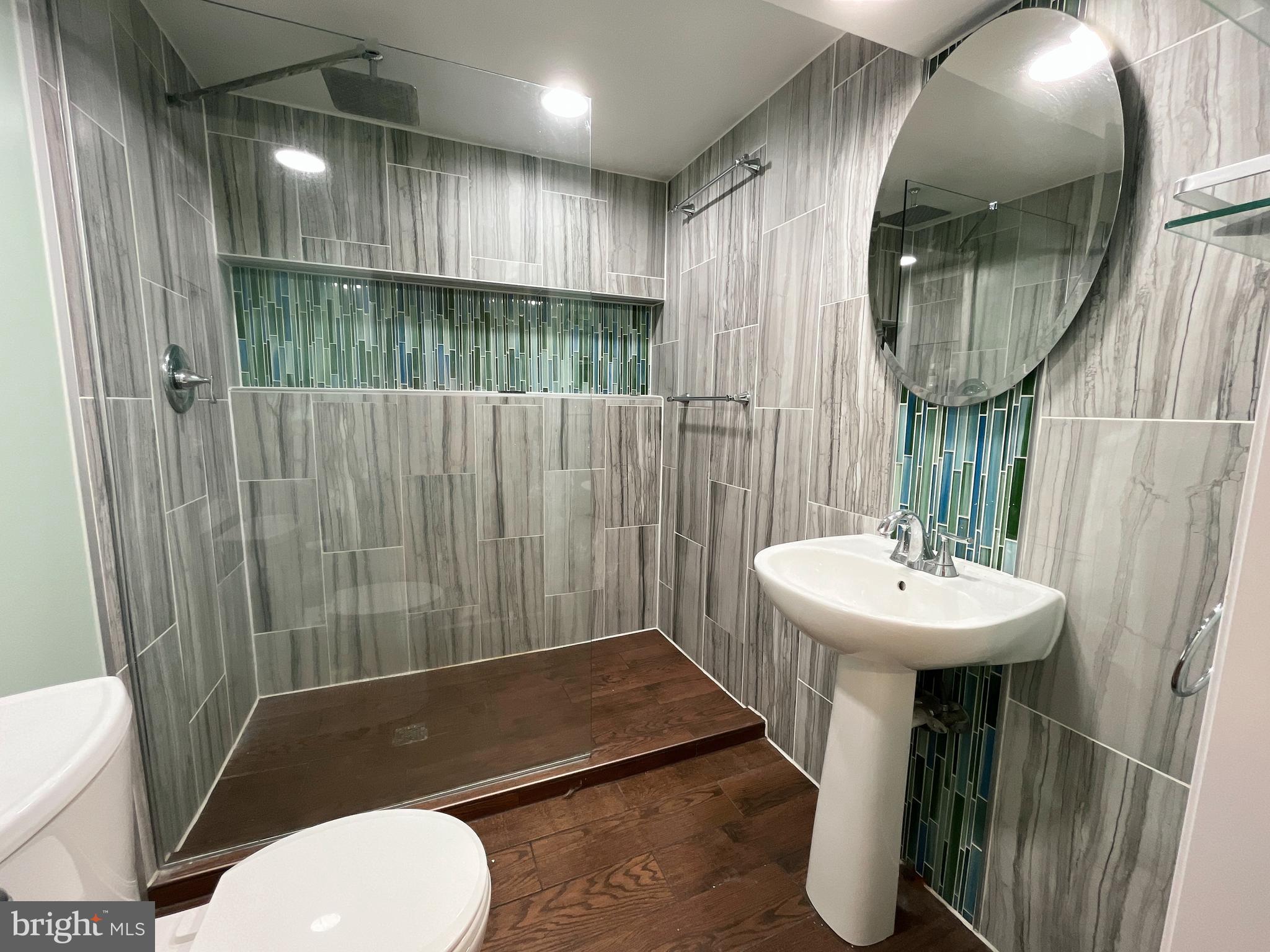 982 Shore Acres Road Arnold, MD 21012 - Photo 19 of 26 a bathroom with a sink a toilet and a mirror