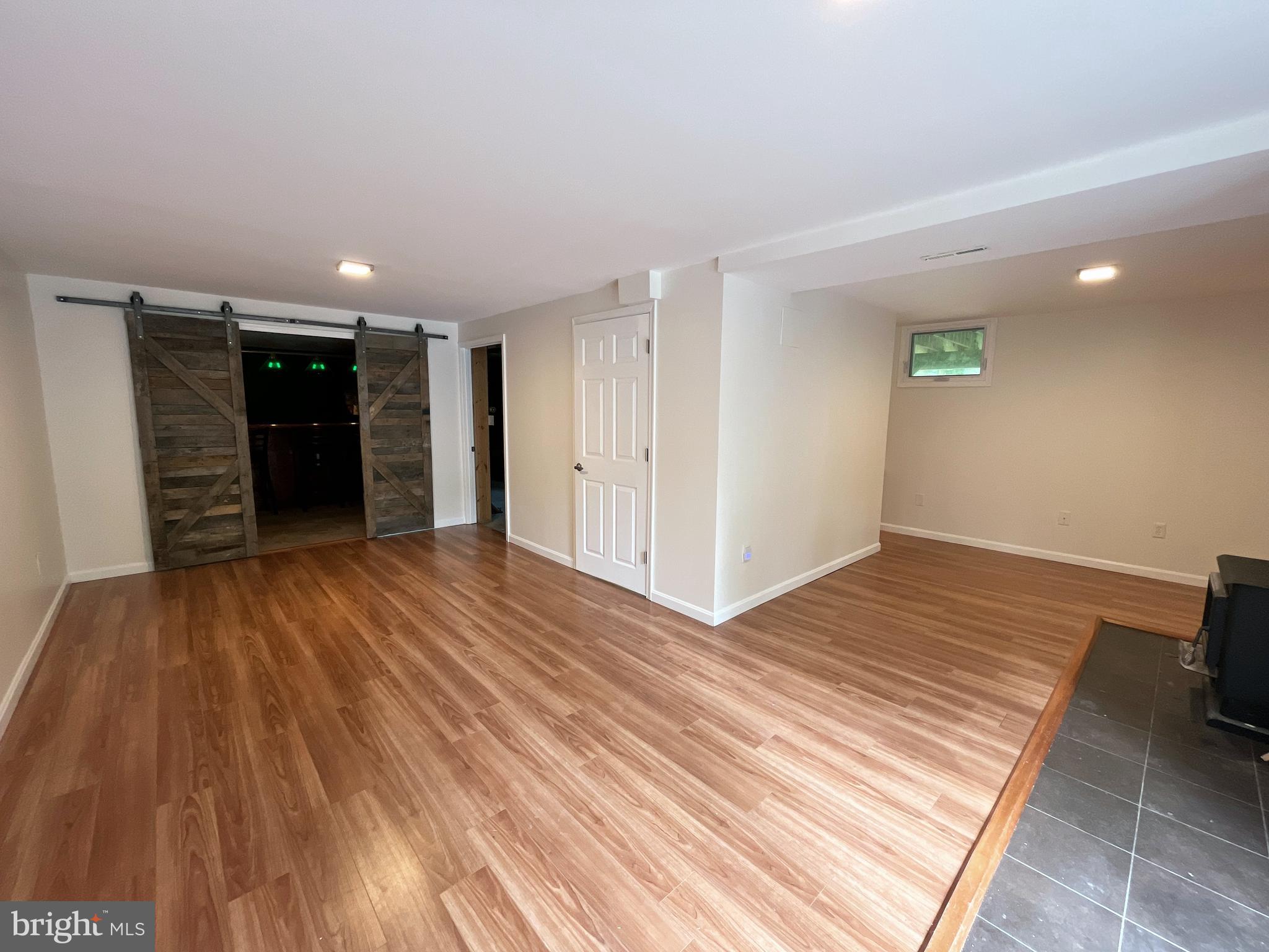982 Shore Acres Road Arnold, MD 21012 - Photo 21 of 26 a view of a big room with wooden floor and closet