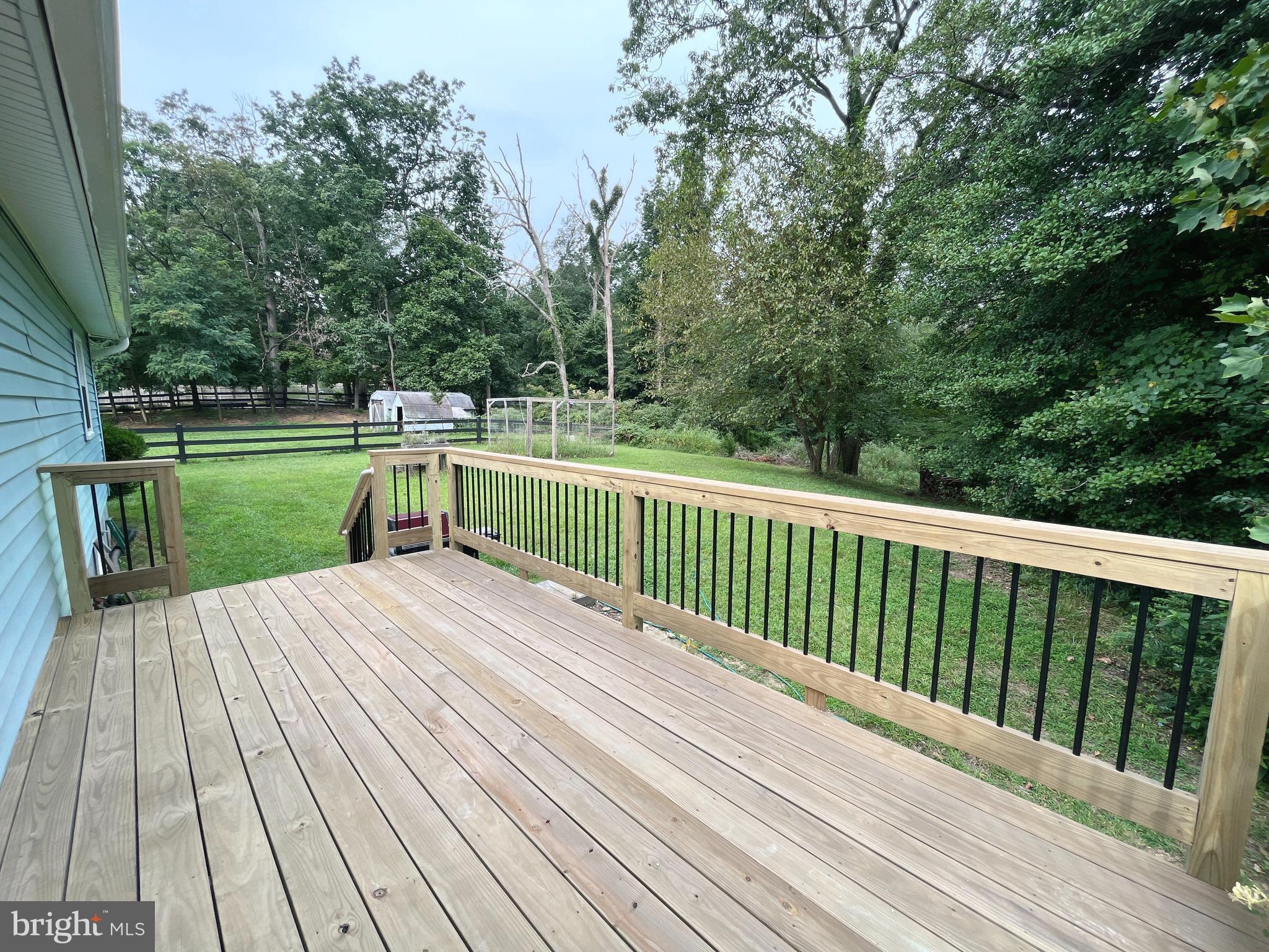 982 Shore Acres Road Arnold, MD 21012 - Photo 5 of 26 a view of backyard with a deck and wooden floor