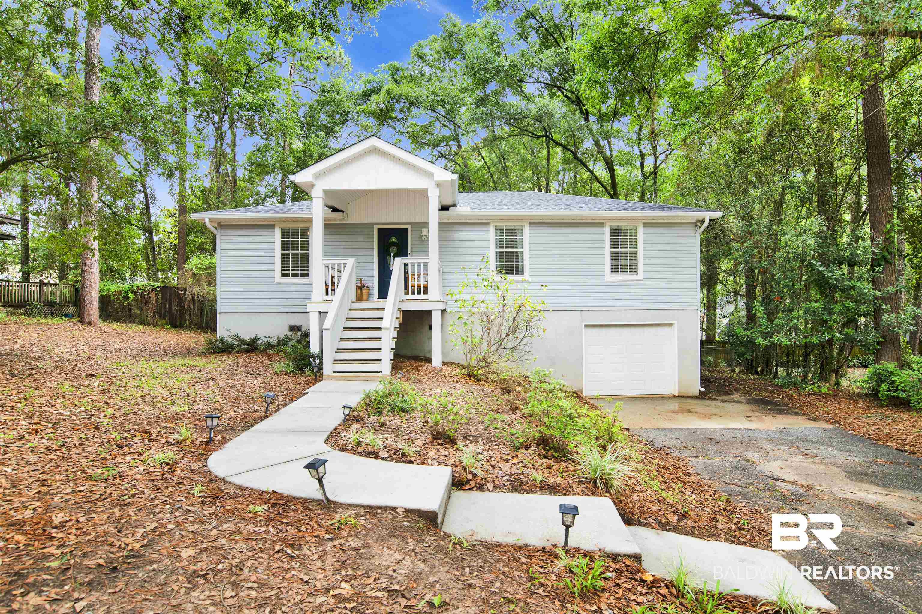 253 Maplewood Loop Daphne, AL 36526 - Photo 1 of 30 Light blue siding exterior with a covered porch and white railings