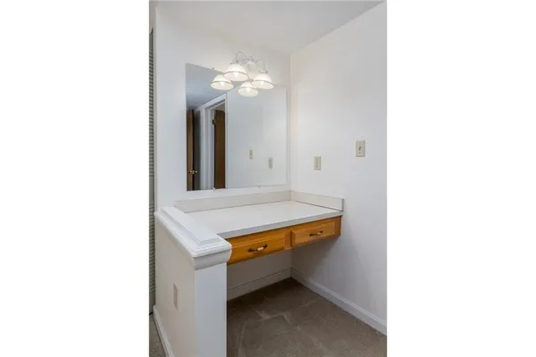 a room with a table and a chandelier