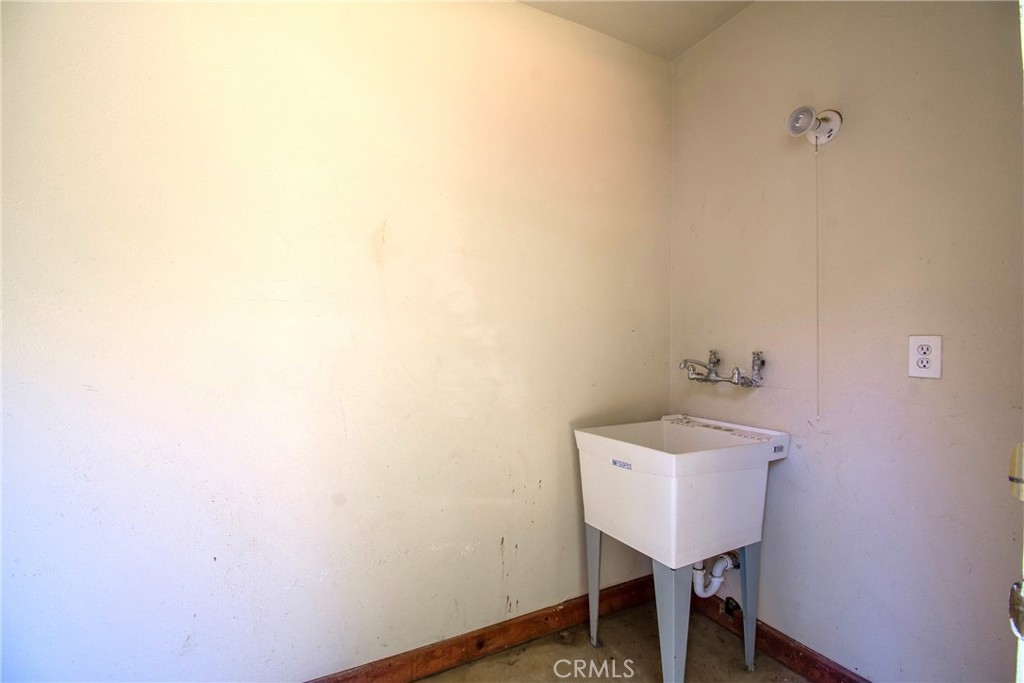 7457 Mt Vernon Street Riverside, CA 92504 - Photo 16 of 16 a bathroom with a sink a mirror and a toilet