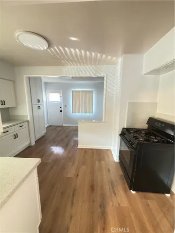 a kitchen with granite countertop a stove and a sink