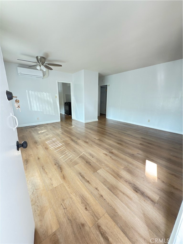 7457 Mt Vernon Street Riverside, CA 92504 - Photo 8 of 16 a view of an empty room with a ceiling fan and window