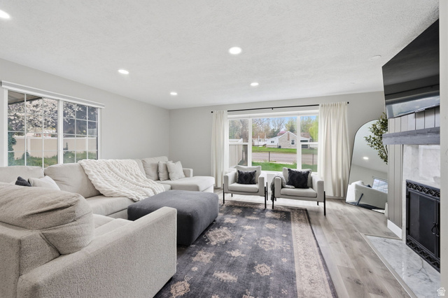 1795 South 200 West Bountiful, UT 84010 - Photo 5 of 37 Living area with a premium fireplace, wood finished floors, and recessed lighting