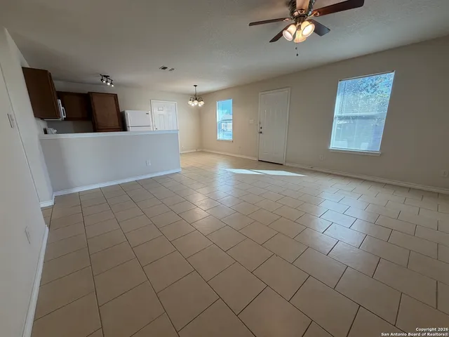 a view of a livingroom with furniture and chandelier fan