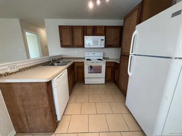 a kitchen with a refrigerator sink and stove