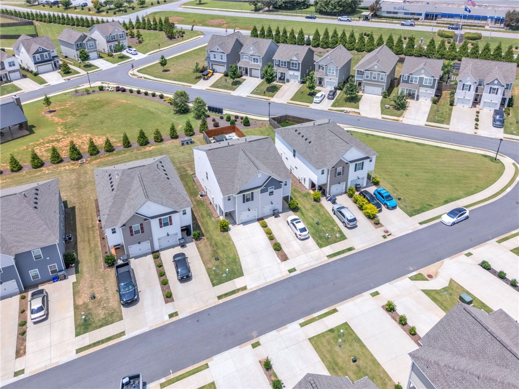 208 Samuel Street Pendleton, SC 29670 - Photo 29 of 32 An aerial perspective reveals a vibrant neighborhood with well-maintained homes and accessible streets.