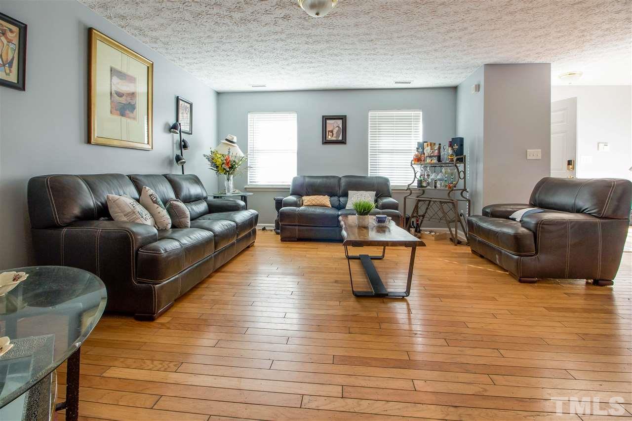 5729 Forest Point Road Raleigh, NC 27610 - Photo 2 of 26 a living room with furniture and a wooden floor