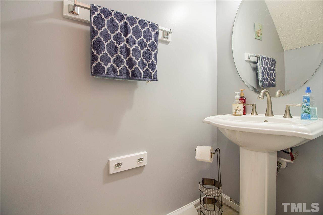 5729 Forest Point Road Raleigh, NC 27610 - Photo 13 of 26 a bathroom with a sink and a mirror