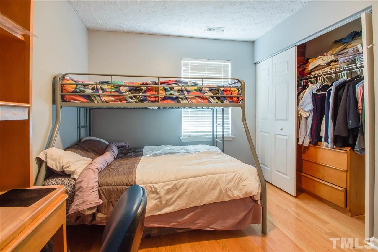 5729 Forest Point Road Raleigh, NC 27610 - Photo 16 of 26 a bedroom with a bed and wooden floor