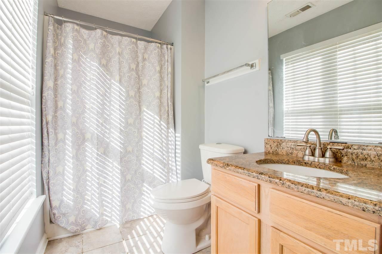 5729 Forest Point Road Raleigh, NC 27610 - Photo 18 of 26 a bathroom with a granite countertop sink and a mirror