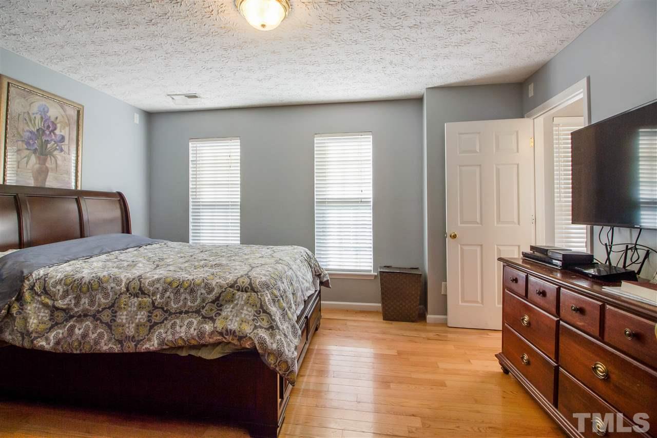 5729 Forest Point Road Raleigh, NC 27610 - Photo 20 of 26 a bedroom with a bed and a flat screen tv