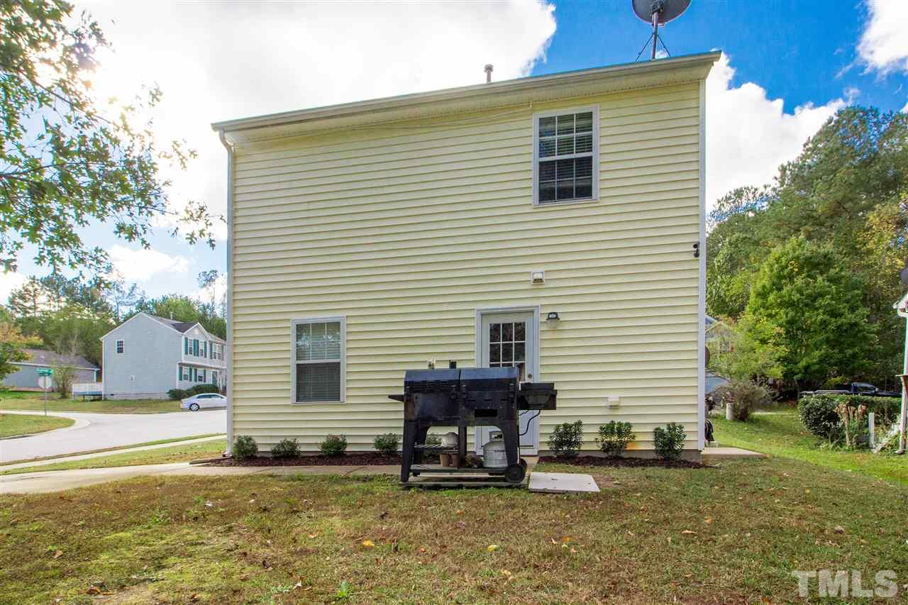 5729 Forest Point Road Raleigh, NC 27610 - Photo 22 of 26 a backyard of a house with table and chairs