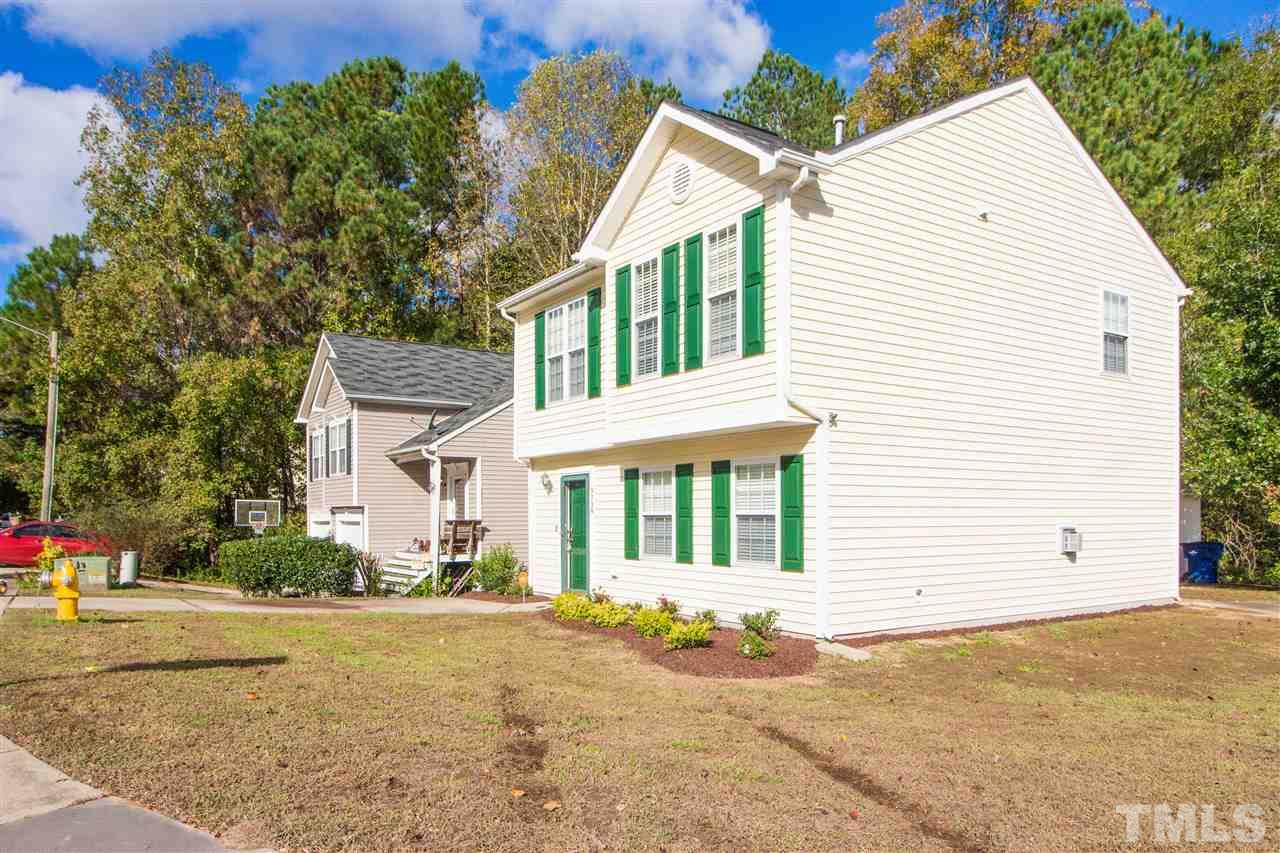 5729 Forest Point Road Raleigh, NC 27610 - Photo 25 of 26 a view of a white house with a large windows