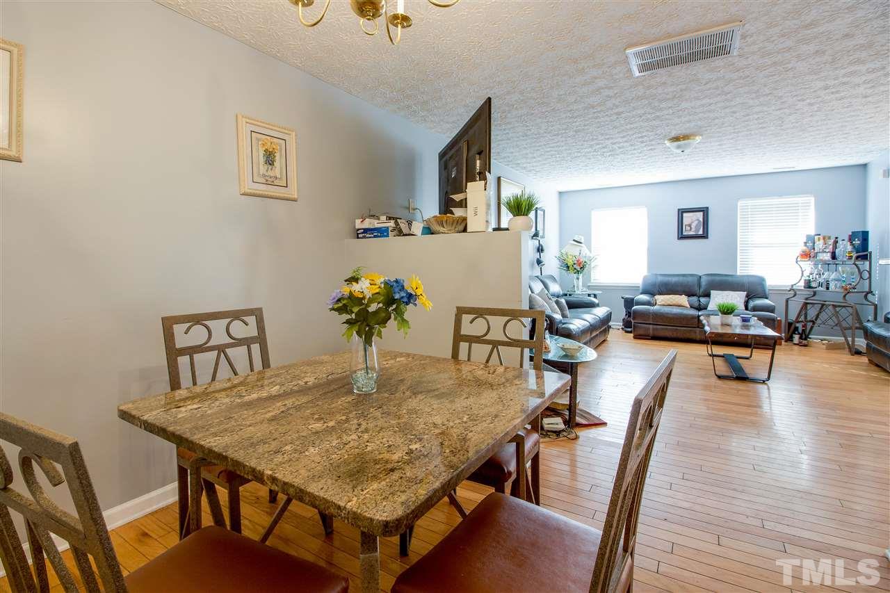 5729 Forest Point Road Raleigh, NC 27610 - Photo 5 of 26 a dining room with furniture and wooden floor