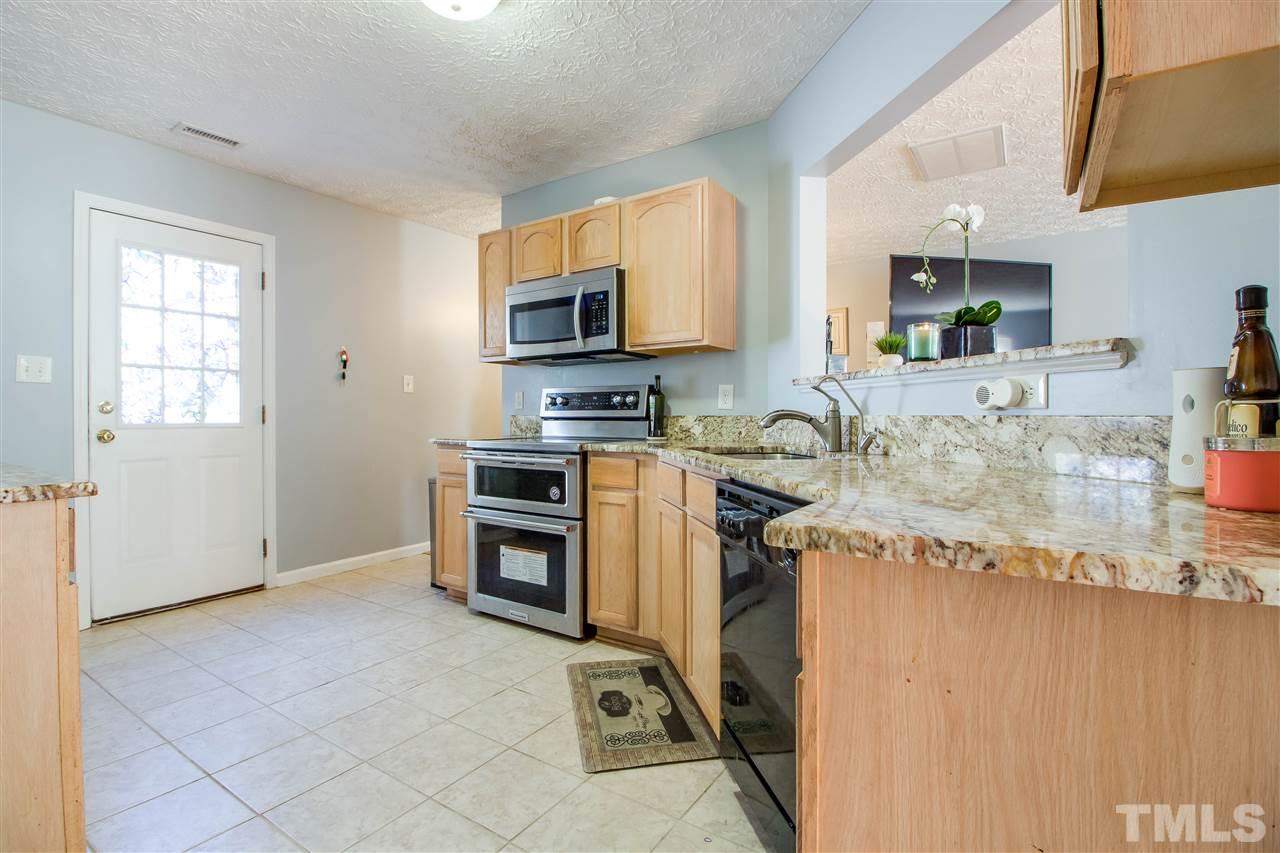 5729 Forest Point Road Raleigh, NC 27610 - Photo 7 of 26 a view of a kitchen with a sink cabinets and a window
